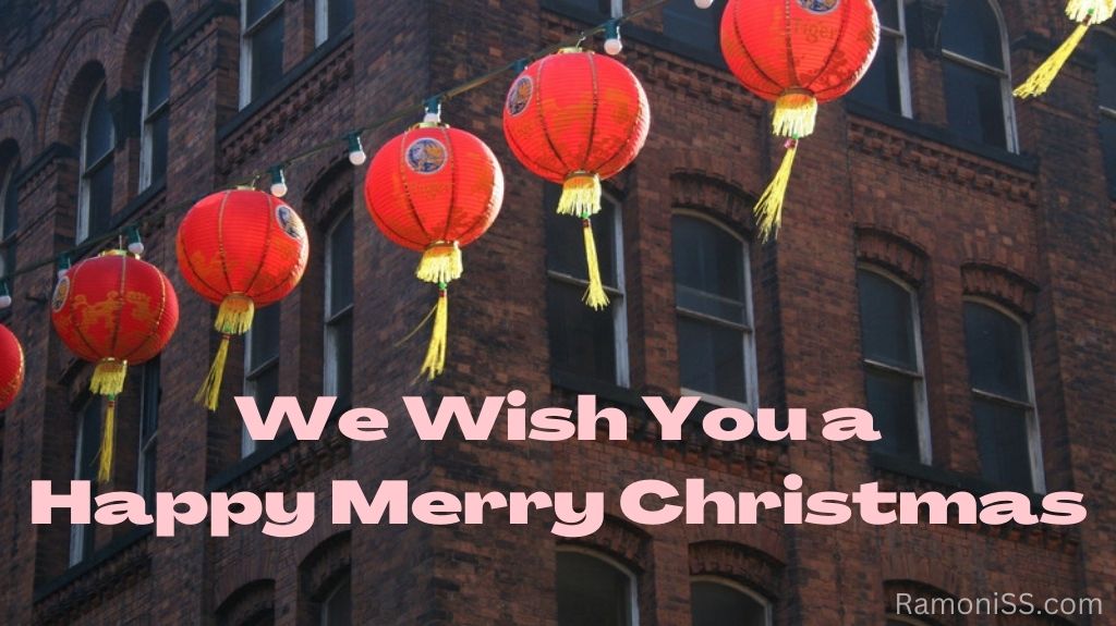 City area is decorated with a frill of christmas lanterns and bulbs, and reads "we wish you a happy merry christmas" in stylish white font.