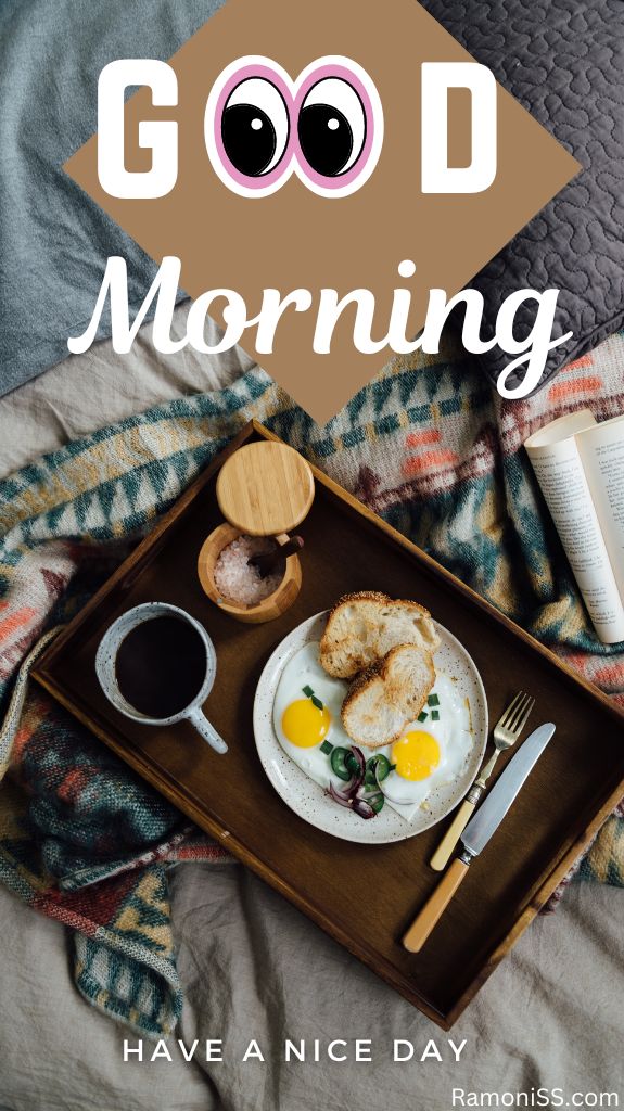 A cup of coffee, a cup of sugar, and a half-fried egg and bread on a white plate are kept in a tray. There is a knife and spoon in the tray, the tray is on the bed, and the image also has a black pillow and an open book on the bed.