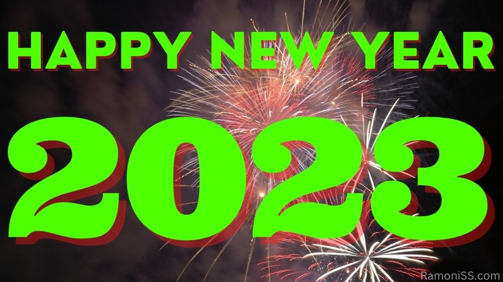 Happy new year 2023 on bright colorful fireworks in the sky using green color font