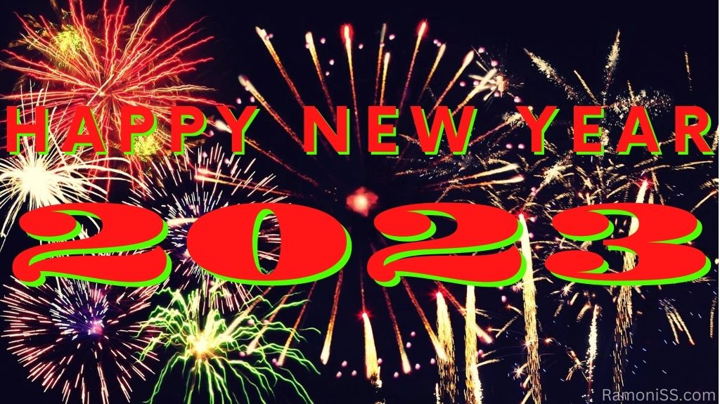 Happy new year 2023 red printed banner on black background with bright colorful fireworks in the sky.