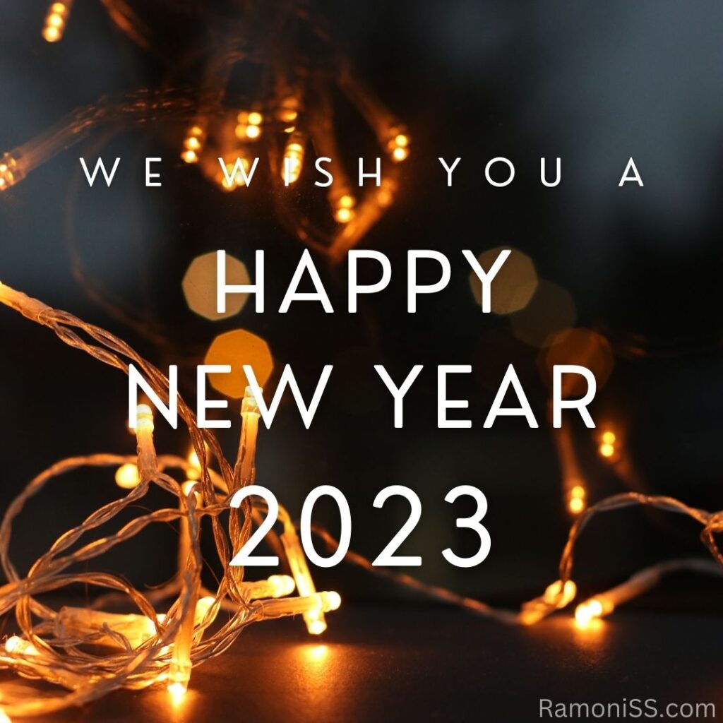Happy new year 2023 using white font, on decoration bulb and colorful background.