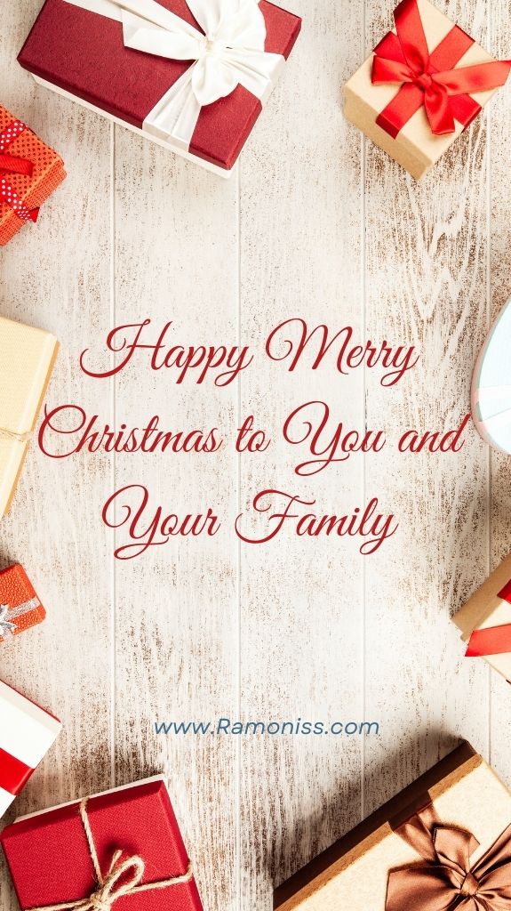 On a white wooden background, happy merry christmas to you and your family is written in stylish red colored fonts. And some packed gifts are kept above the background.