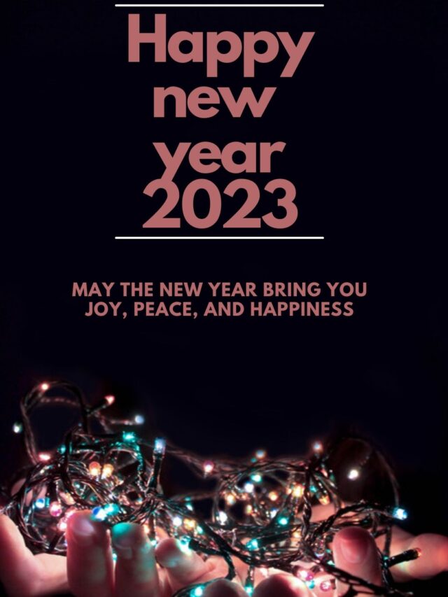 Happy new year 2023 using light pink font, on decoration bulb on the hands and colorful background.