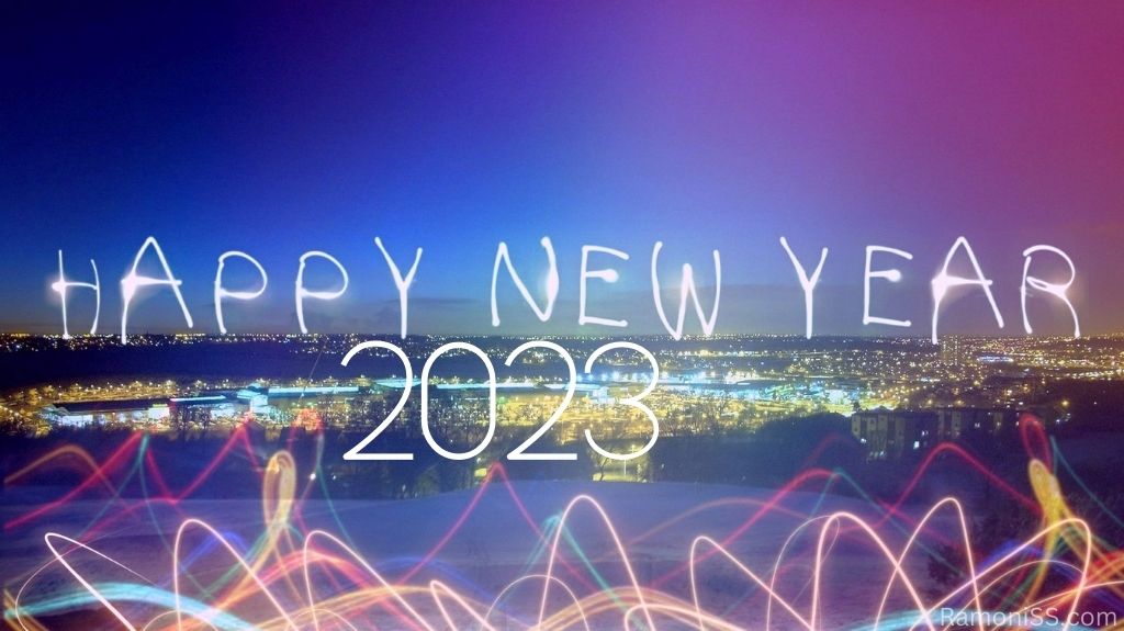 Happy new year year 2023 the lights are on all over the city on the river bank big colorful background