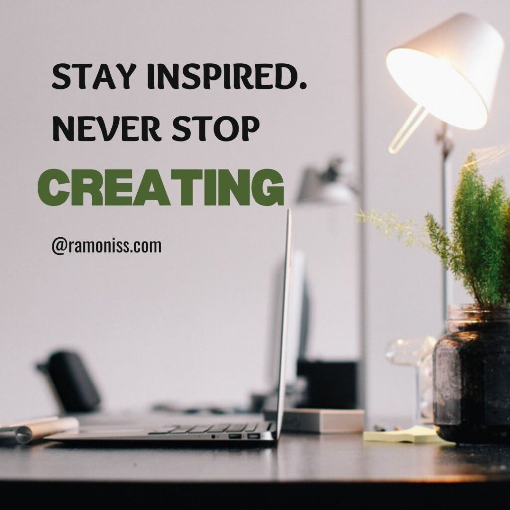 The image has a vase, laptop, table lamp, and book on a table. The image has fonts that say stay inspired, never stop creating.