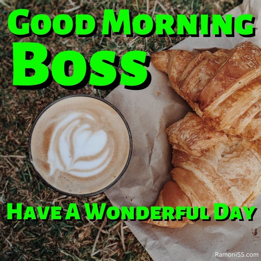 In the photo, a cup full of coffee is placed on the grass and two cookies are placed on the paper, in the photo good morning boss is also written.