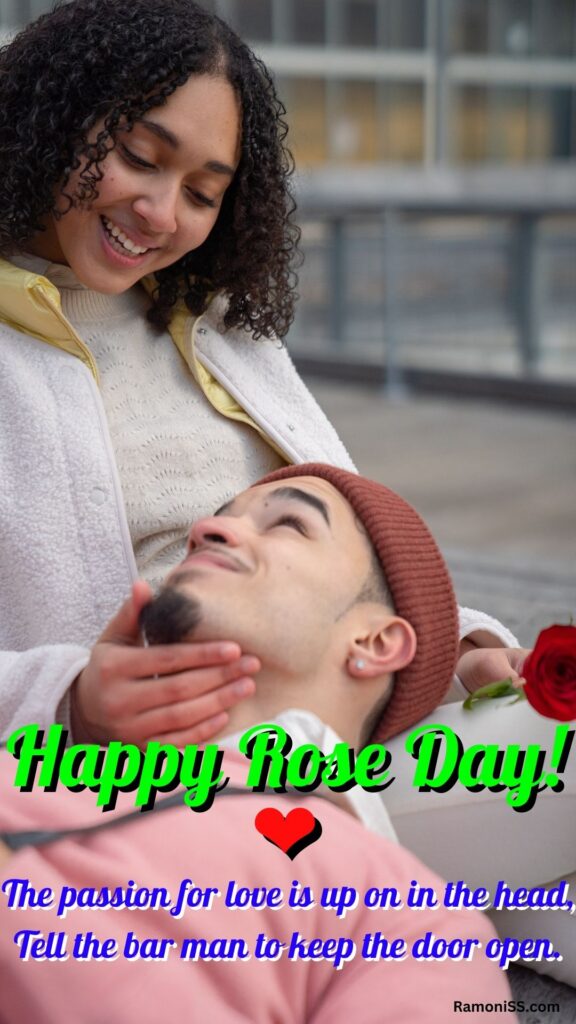In the photo, the boy is lying with his head on his girlfriend's lap and the girlfriend is laughing and looking at his face. The girl is holding a rose flower.