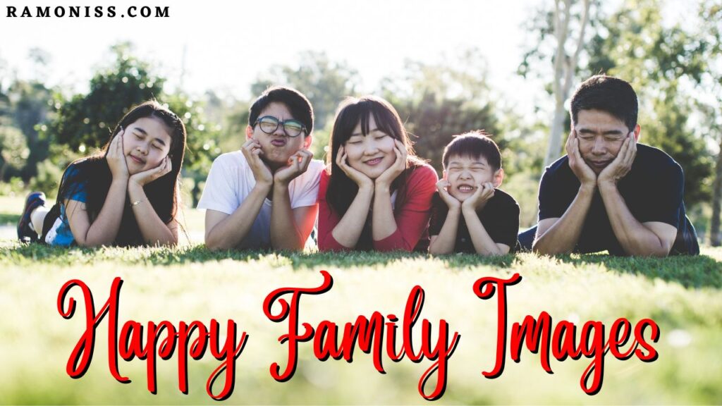 This is the thumbnail images of happy family images post, in this image five members of a family are lying on the grass in a park and making faces like emoji with their hands on their chins.
