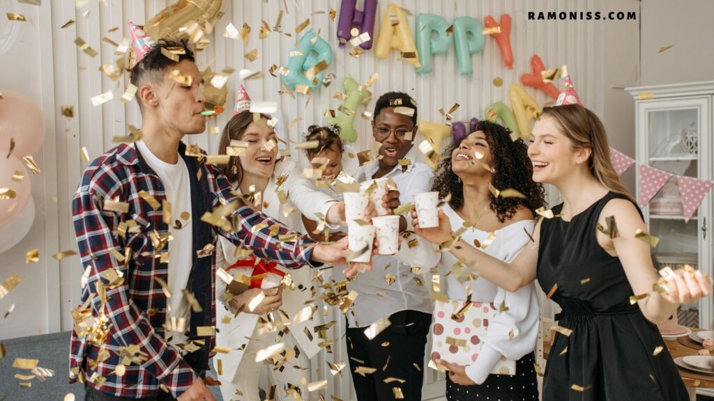 In the photo, 6 members of a happy family are celebrating the birthday. There is also a small girl in the photo who is in the lap of her mother. The room is decorated with decorative material.