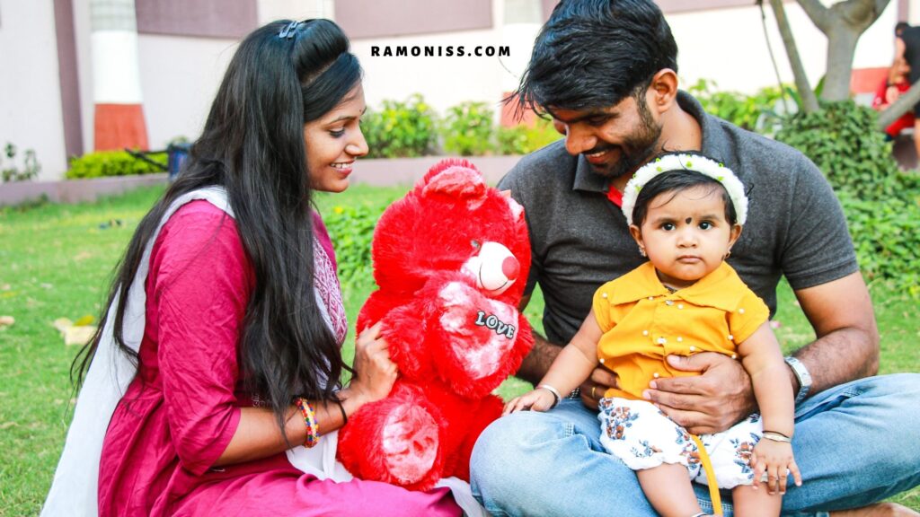 Happy indian family sitting in the park with teddy bear toy.