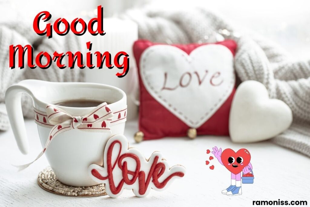 Coffee cup tied with ribbon white heart and love printed pillow and sweater placed on the white surface good morning love images for my girlfriend.